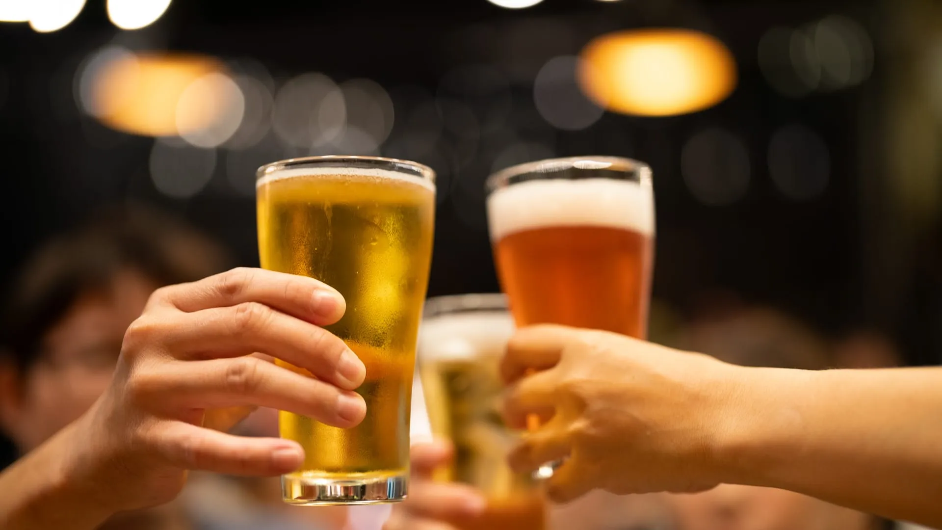A group of friends celebrating with beer in cheers.
