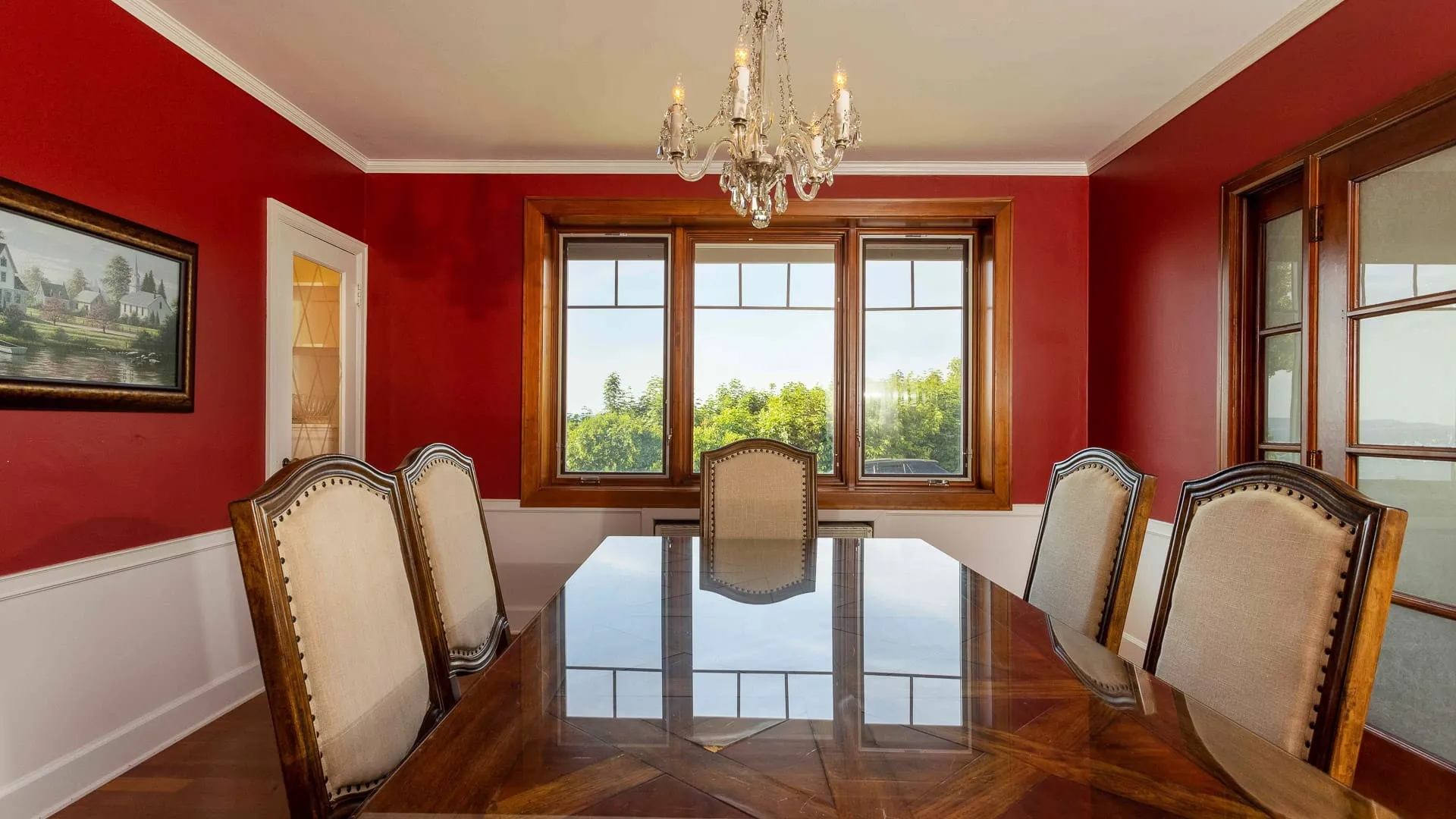A red dining room with table and chairs.