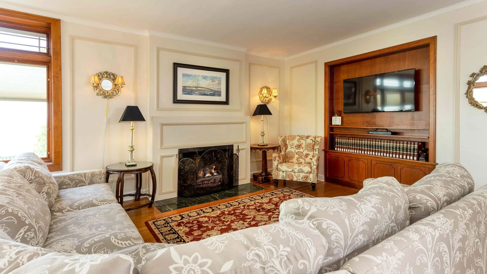 A living room with fireplace, couch, and television.