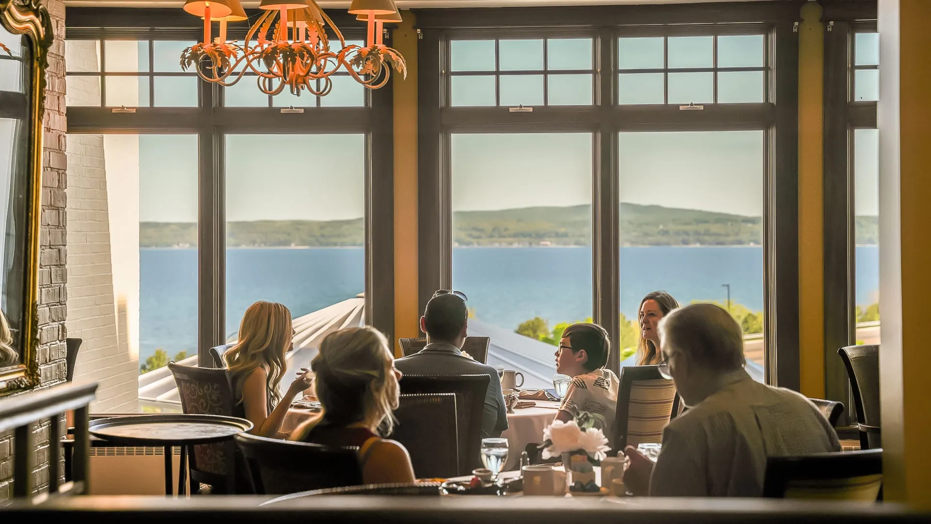 people at dinner at a restaurant lakeside.
