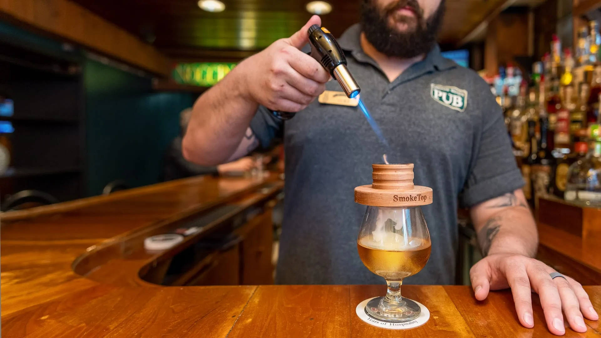 Bartender smoking beer.