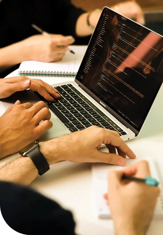 A group of people working at a laptop