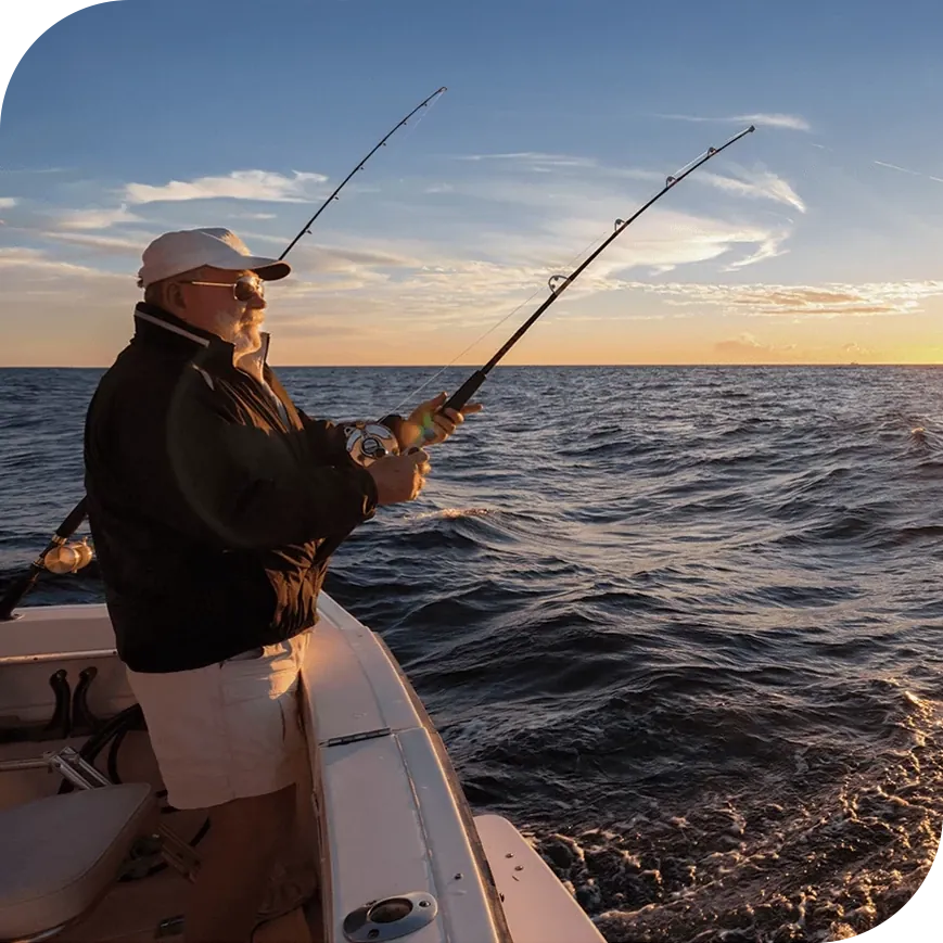 A man fishing on a boat in a lake.