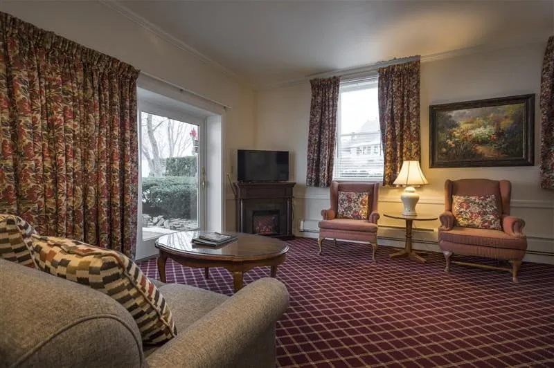 Hotel bedroom with red carpet with view of television.