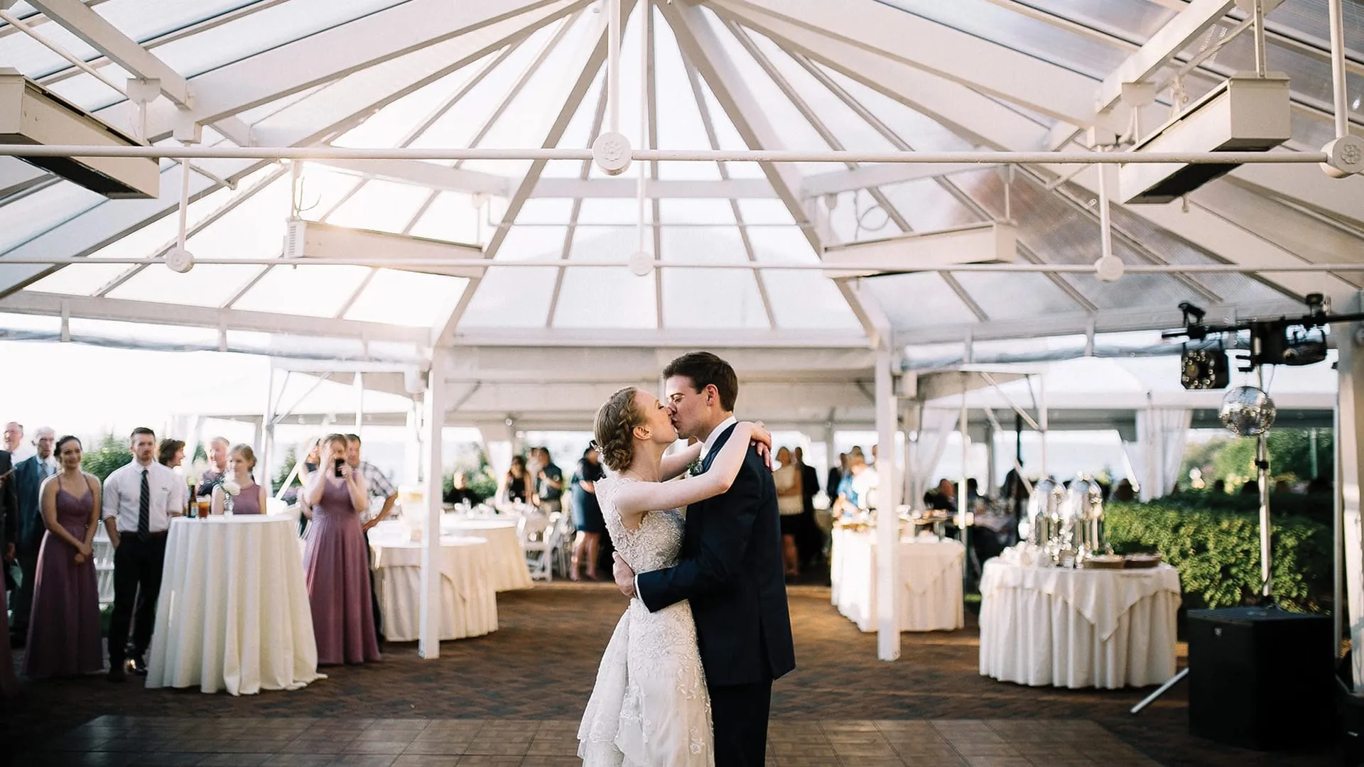 Bride and groom kissing at wedding reception.