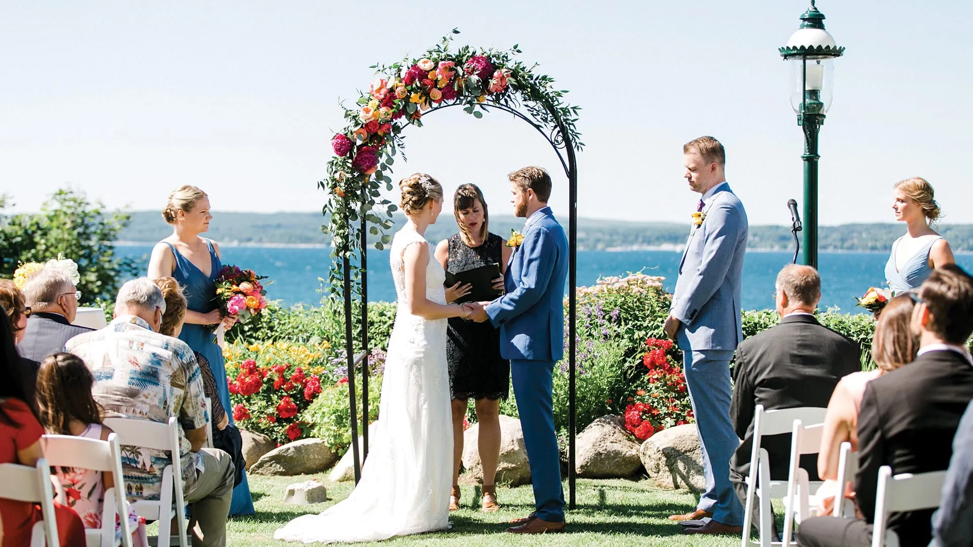 Bride and groom at wedding ceremony with family.