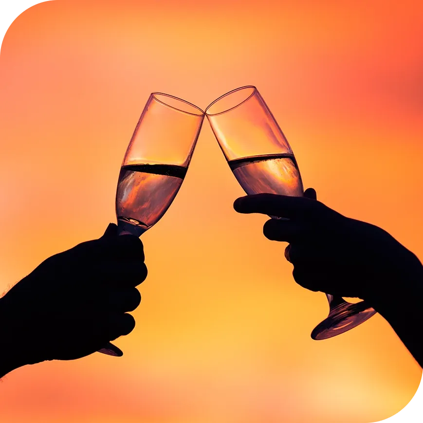 a couple cheersing with champagne and flutes.