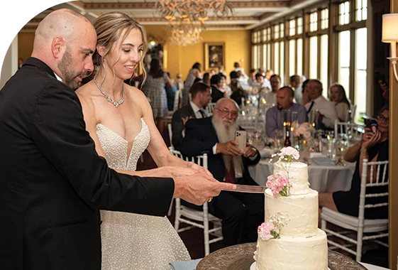 A bride and groom cutting their wedding cake.